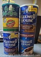 Front view of four stacked vintage coffee cans showing full labels