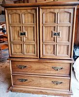 Front view of solid wood MCM bureau showing paneled upper doors and two lower drawers