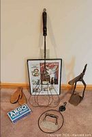 Group shot of all items in lot: framed Rinso print, wooden mitten forms, rug beater, bottle capper, Argo starch box