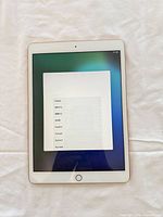 Front view of Apple iPad A2197 showing setup screen and Touch ID home button