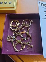 assorted jewelry pieces in box