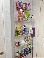 Vertical wire rack showing multiple cleaning and laundry products on five shelves