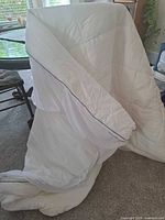 White queen comforter displayed to show gray trim and overall condition