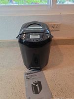 Bread maker with manual placed on countertop