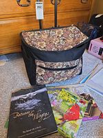 Overview of rolling tote bag with floral tapestry panel, book and magazines