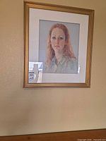 Full view of framed pastel portrait on wall