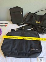 Overview of all four black bags showing brands, sizes and straps