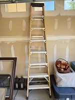 Full view of Husky fiberglass step ladder leaning against wall