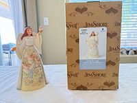 Angel figurine next to original box front view