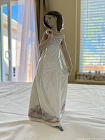 Front view of Lladró figurine showing pose, dress details, and height context