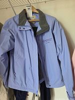 Front view of light purple L.L.Bean jacket showing zipper, snaps, chest logo, fleece collar