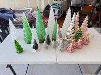Overall lot showing all Christmas trees on table