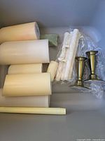 Group of pillar candles, taper candles in wrap, brass holders
