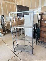 Full view of gray metal 5-shelf Origami rack on casters