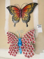 Both butterfly wall decor pieces hanging side by side