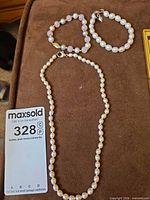 Necklace and two bracelets laid out showing overall design