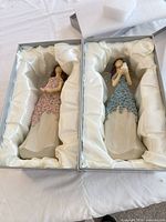Both boxed angel figurines side by side