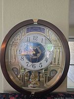Front view of Seiko Melodies in Motion wall clock showing full design