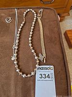 All items laid out: beaded necklace, ladder-link bracelet, hoop earrings