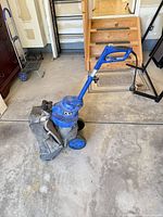 Full view of Sun Joe SBJ802E mower showing handle, wheels and attached grass bag