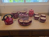 Full lot view showing kettle, stockpot, casseroles, cookie jar, ramekins, serving tray with bowls, glass jars