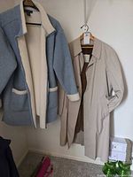 Both coats hanging side by side showing overall style, colors and lengths