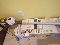 Dyson V7 main unit on original box with charger cable visible