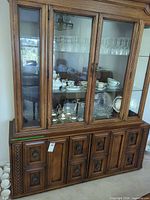 Full frontal view of china cabinet showing upper glass doors and lower wood doors