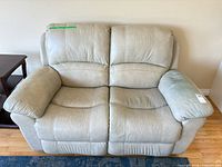 Front view of light gray leather loveseat