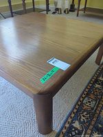 overall view of wooden coffee table corner showing grain and leg