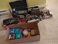 Overall lot showing toolboxes, organizer drawers, power strip, extension cords and box of light bulbs