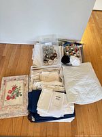 full lot showing linens, placemats, napkin rings, sewing bin
