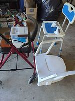 Rollator, shower chair and raised toilet seat grouped
