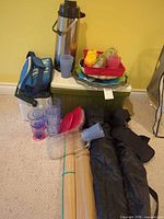 Group shot showing airpot, coolers, chairs, bamboo mats, plastic serveware