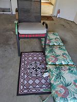 Overall view showing chair, cushions, rugs