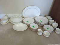 entire dinnerware set arranged on floor showing all stacks and serving pieces