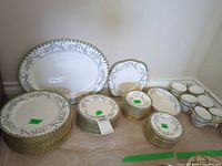 Entire set laid out showing platter, stacks of plates in various sizes and cups