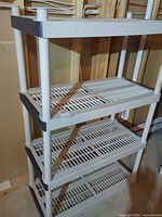 Full view of assembled 4-shelf unit showing structure and color