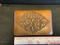 Top view showing carved maple leaf motif and size reference