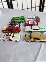 Eight Hot Wheels cars arranged in two columns, angled view