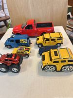 All seven vehicles grouped on white surface