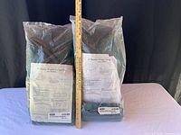 Both plastic-wrapped wreath storage bags beside yardstick for scale