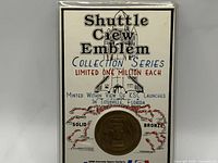 Front view full packaging showing coin and printed card