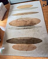 Full view of rug showing abstract oval design and overall condition