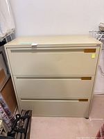 front view of beige three-drawer lateral file cabinet