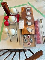 Entire lot overview showing wood tray with glass cups, metal stand, amber glass panel, assorted candles and snuffers
