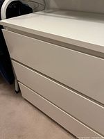 Front view of white 3-drawer dresser