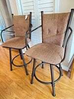Front view of both bar stools showing overall design and condition