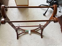 Full overhead view of wooden quilt rack showing two rails and side supports