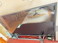 Front view of 40-inch Sony TV on stand with remote visible